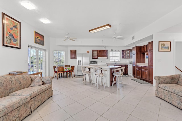 tiled living room featuring ceiling fan