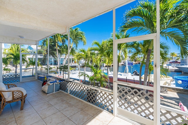 sunroom / solarium with a water view