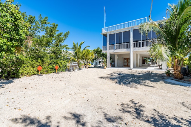 rear view of property with a sunroom