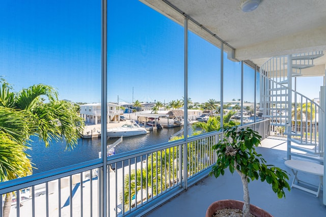 unfurnished sunroom featuring a water view