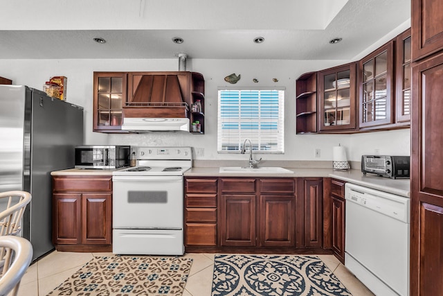 kitchen with light tile patterned flooring, appliances with stainless steel finishes, and sink