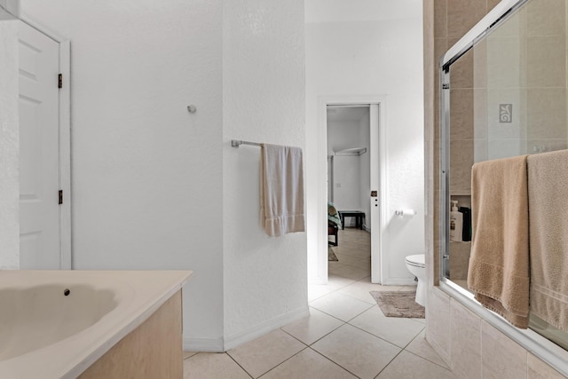 bathroom with an enclosed shower, tile patterned floors, and toilet