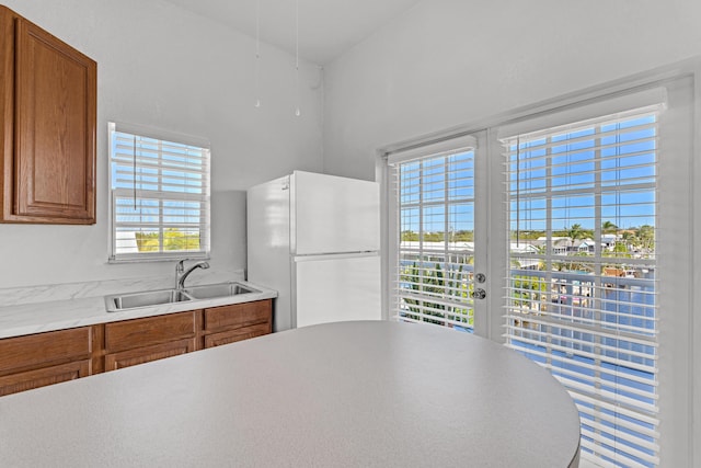 kitchen featuring white refrigerator, sink, and french doors