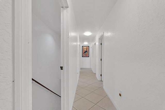 hall featuring light tile patterned floors