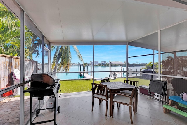 sunroom featuring plenty of natural light and a water view