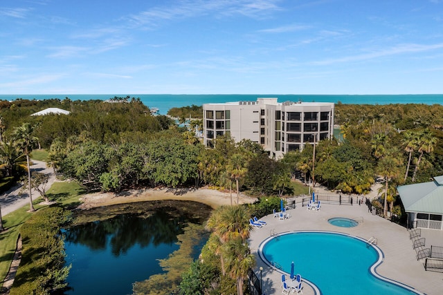 view of pool featuring a patio, a water view, and a community hot tub