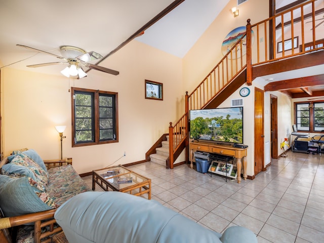 tiled living area featuring visible vents, beam ceiling, a ceiling fan, stairway, and baseboards