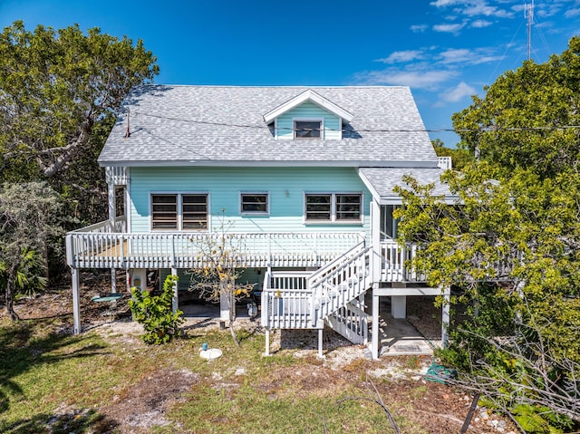 back of property featuring a patio, a wooden deck, stairway, and a shingled roof