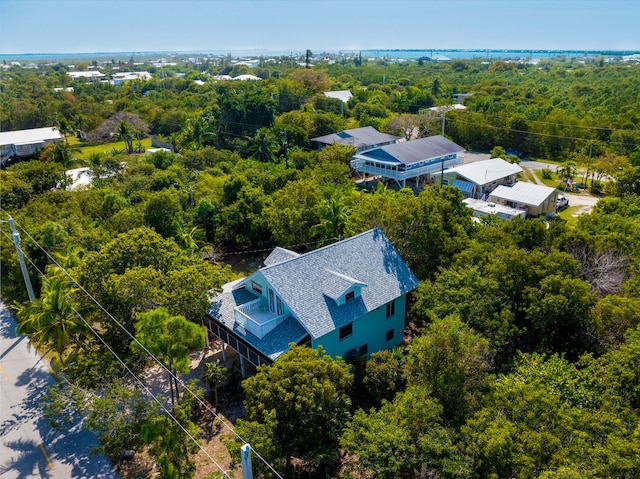 birds eye view of property featuring a wooded view