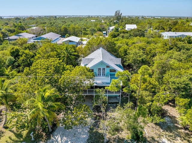 birds eye view of property with a wooded view