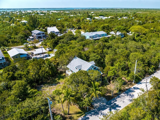 birds eye view of property with a view of trees