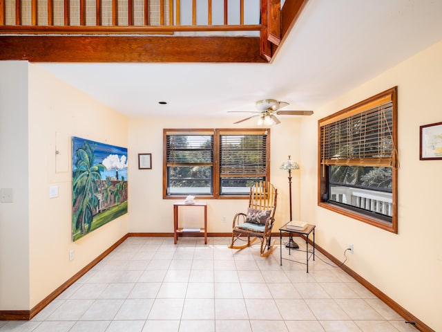 sitting room with light tile patterned flooring, a ceiling fan, and baseboards