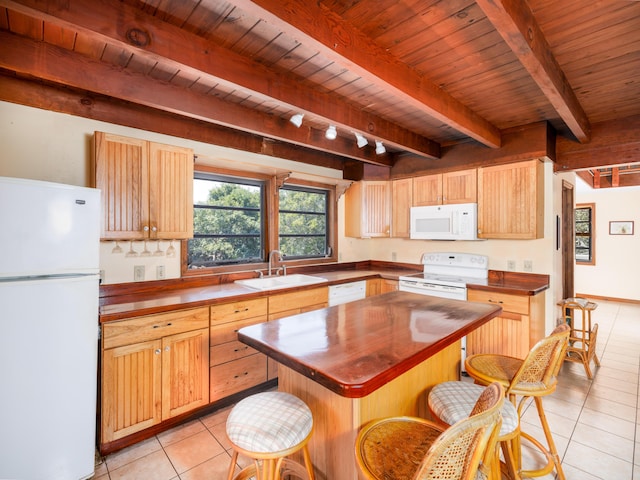 kitchen featuring white appliances, light tile patterned floors, wooden counters, a sink, and beamed ceiling