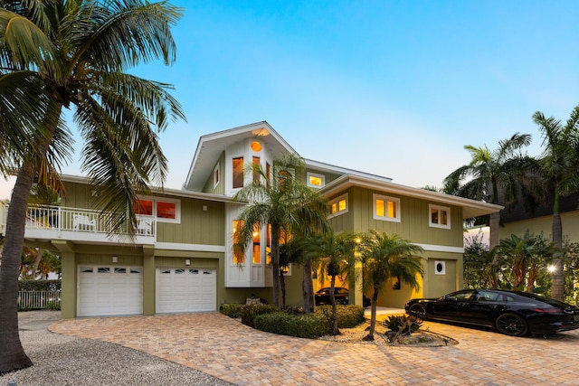 view of front of property with a garage and a balcony