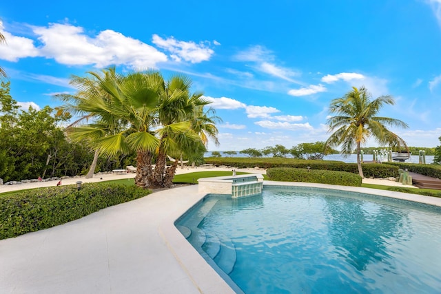 view of swimming pool featuring a hot tub