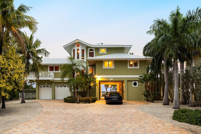 coastal home featuring a garage and a balcony