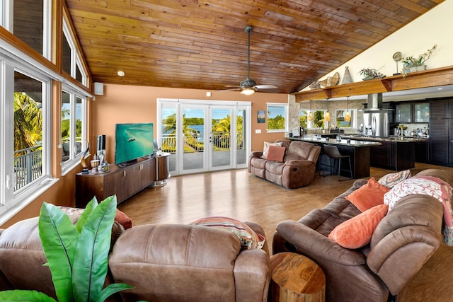 living room featuring lofted ceiling, wood ceiling, and a healthy amount of sunlight