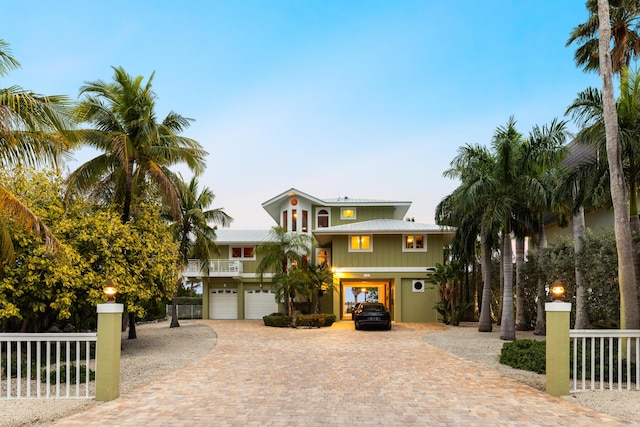 coastal home with a balcony and a garage