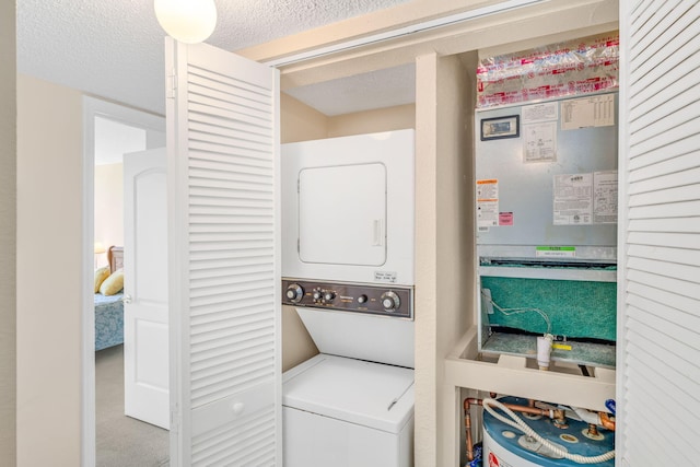 104350 Overseas Hwy Unit B203, Key Largo, FL 33037 - laundry room with stacked washing machine and dryer and a textured ceiling