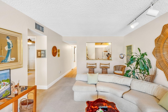 104350 Overseas Hwy Unit B203, Key Largo, FL 33037 - living room with light colored carpet, rail lighting, and a textured ceiling