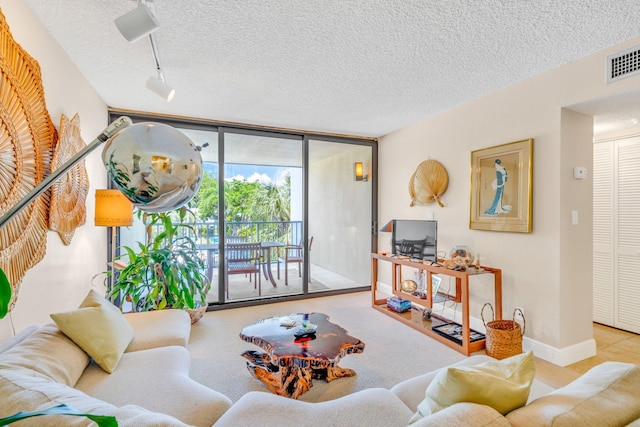 104350 Overseas Hwy Unit B203, Key Largo, FL 33037 - living area featuring a textured ceiling, a wall of windows, and track lighting
