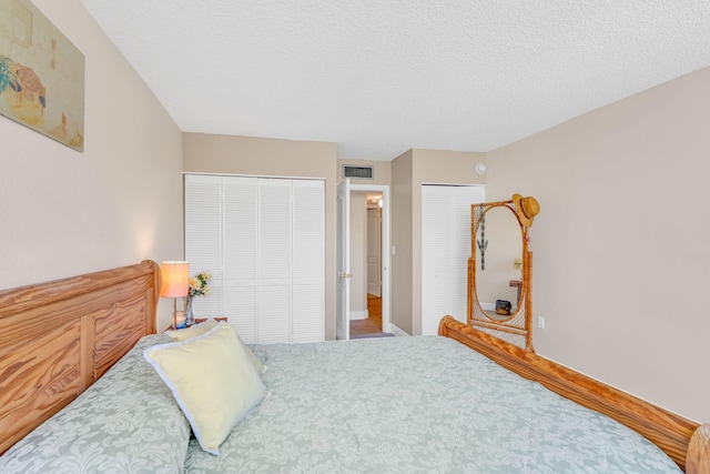 104350 Overseas Hwy Unit B203, Key Largo, FL 33037 - bedroom with multiple closets and a textured ceiling