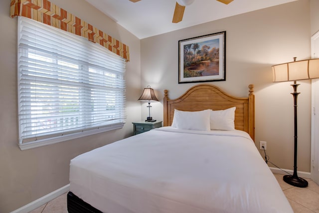 tiled bedroom with ceiling fan