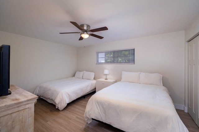 88181 Old Hwy Unit 3F, Islamorada, FL 33036 - bedroom with wood finished floors, ceiling fan, and a closet