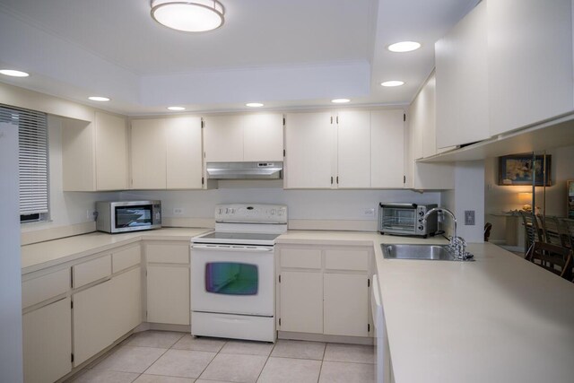 88181 Old Hwy Unit 3F, Islamorada, FL 33036 - kitchen with electric stove, stainless steel microwave, under cabinet range hood, recessed lighting, and light tile patterned flooring