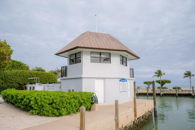 88181 Old Hwy Unit 3F, Islamorada, FL 33036 - view of side of property featuring a water view, stucco siding, and a metal roof