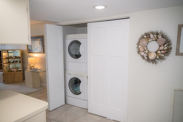 88181 Old Hwy Unit 3F, Islamorada, FL 33036 - laundry room with estacked washer and dryer and light tile patterned flooring