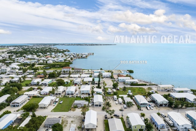 birds eye view of property with a water view and a residential view