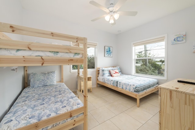 bedroom with multiple windows and light tile patterned floors