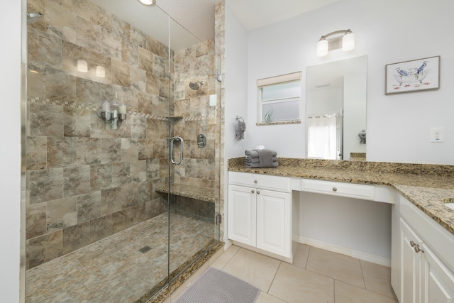 bathroom featuring vanity, an enclosed shower, and tile patterned flooring