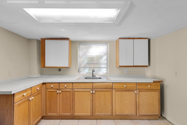 kitchen featuring sink and light tile patterned floors