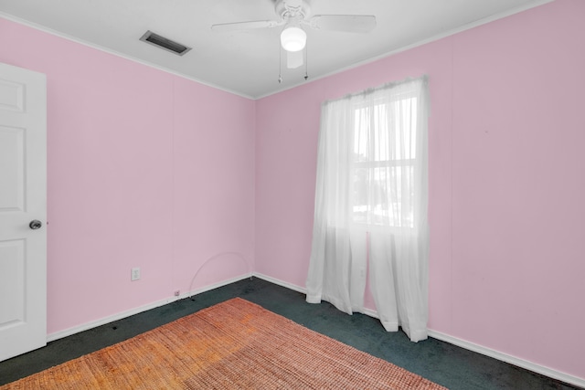 carpeted empty room with crown molding and ceiling fan