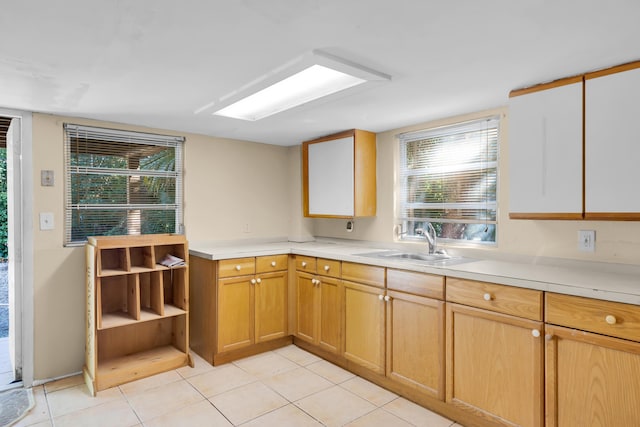 kitchen with light tile patterned flooring and sink