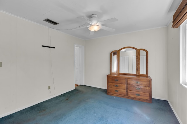 unfurnished bedroom featuring ornamental molding, ceiling fan, and dark colored carpet