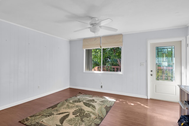 entrance foyer with hardwood / wood-style flooring, ceiling fan, and crown molding