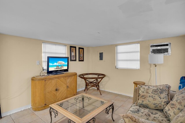 living room with a wall mounted air conditioner and light tile patterned floors