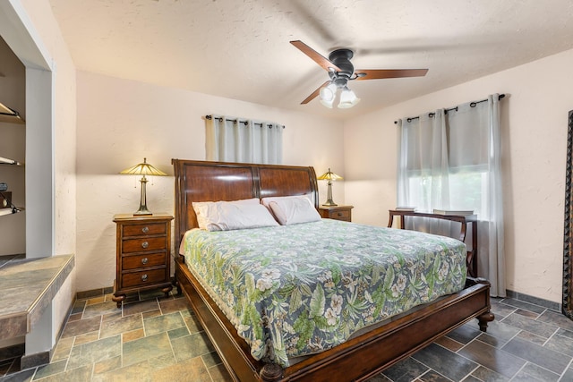 bedroom with a textured ceiling and ceiling fan