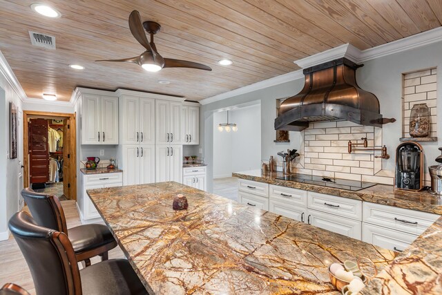 kitchen with crown molding, black electric stovetop, white cabinets, custom exhaust hood, and wooden ceiling