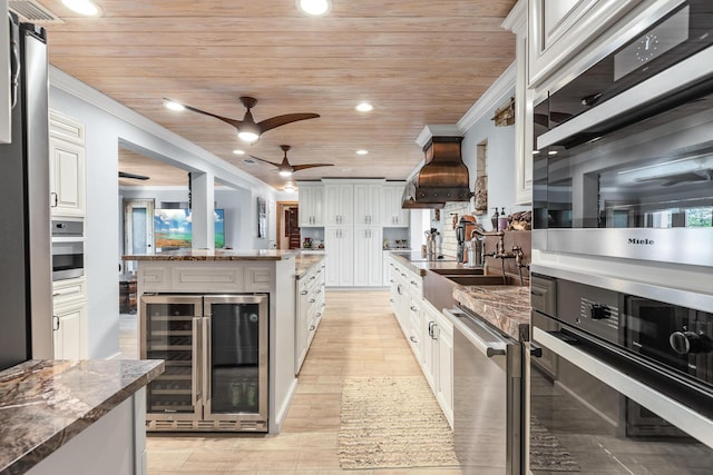 kitchen with wood ceiling, beverage cooler, custom range hood, and white cabinets