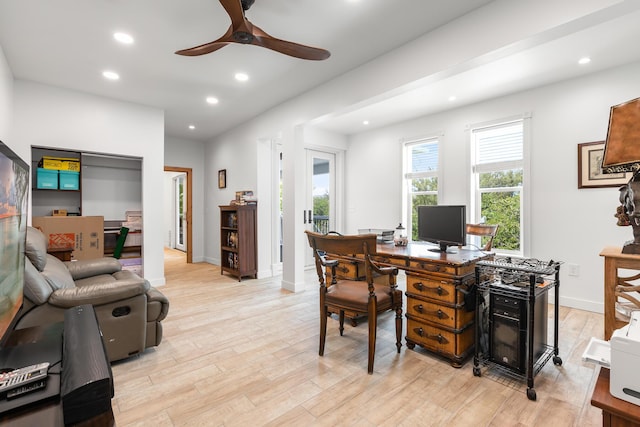 office area with light hardwood / wood-style floors and ceiling fan