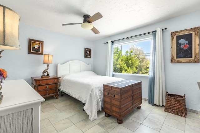 bedroom featuring ceiling fan and light tile patterned floors