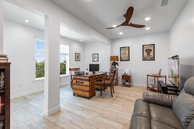 home office with ceiling fan and light hardwood / wood-style flooring