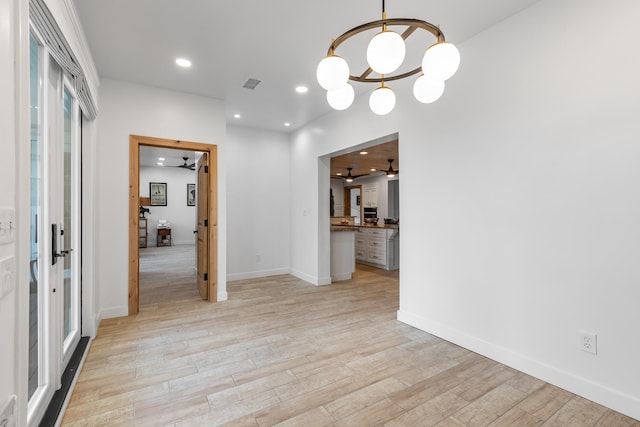 unfurnished dining area with light hardwood / wood-style floors and ceiling fan