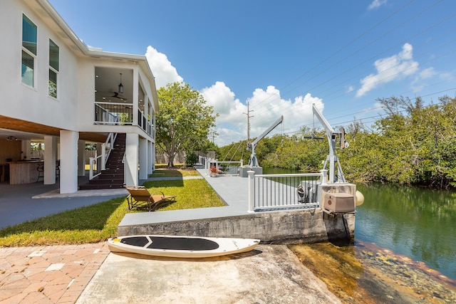 exterior space with a water view and ceiling fan