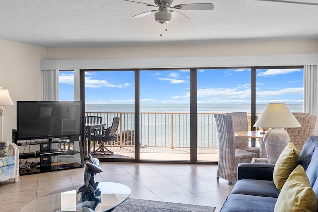 tiled living room with ceiling fan