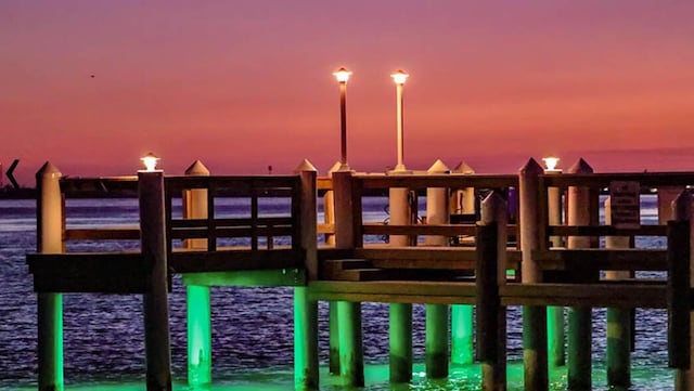 playground at dusk featuring a water view